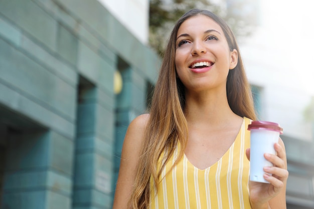 Portrait of young woman walking in the city