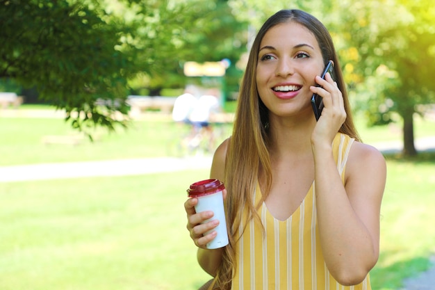 Portrait of young woman walking in the park