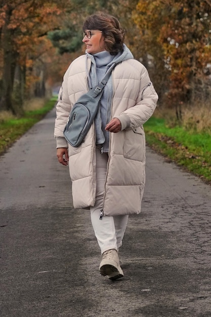 Portrait of young woman walking on road