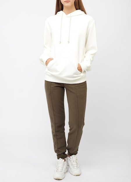 Portrait of young woman wearing grey sportswear sweatshirt hoodie, isolated studio image on white background