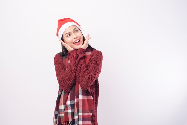 A portrait of young woman wearing red Santa hat