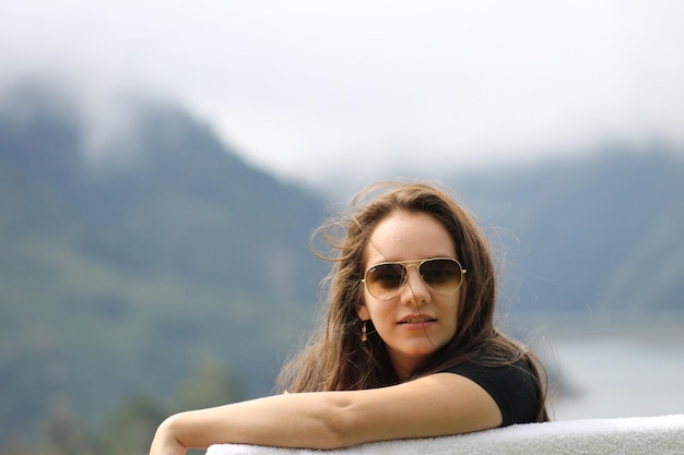 Portrait of young woman wearing sunglasses outdoors