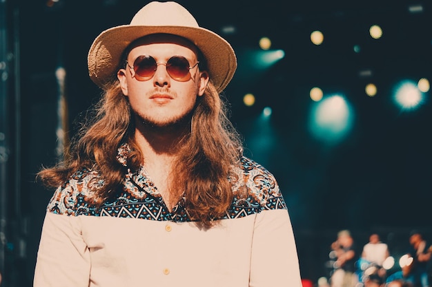 Portrait of young woman wearing sunglasses standing outdoors