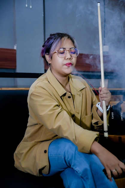 Portrait of young woman wearing sunglasses while standing in gym