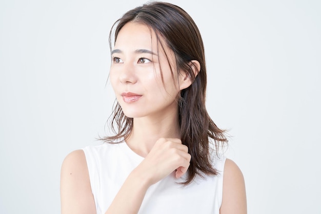 Portrait of young woman and white background