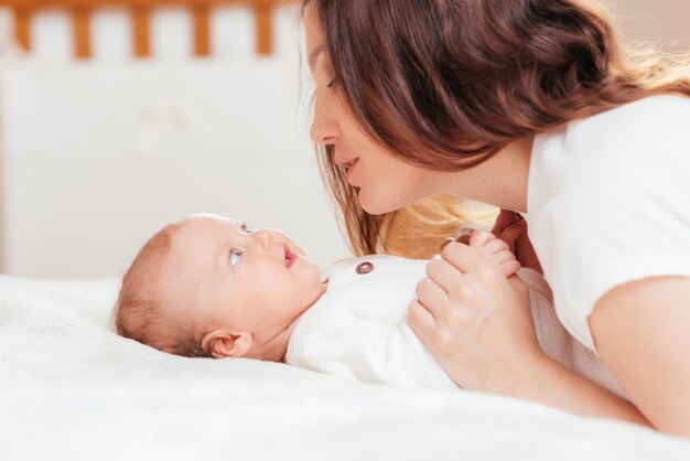 Portrait of a young woman who tenderly cares for her baby