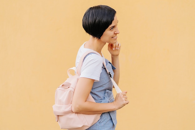 Portrait of young woman with a backpack 