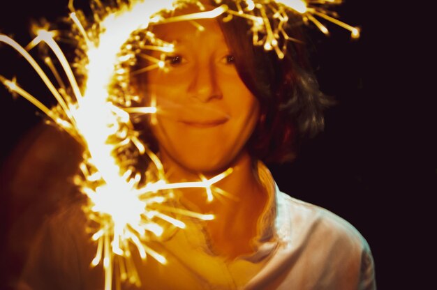 Portrait of young woman with burning candle