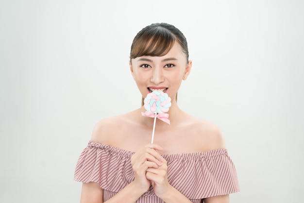 Portrait Young woman with candy on white