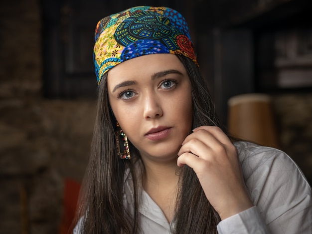 Portrait young woman with colorful headscarf.