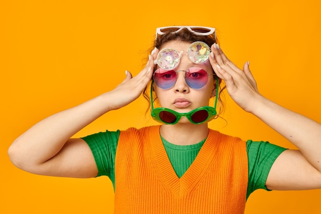 Portrait of young woman with face paint against yellow background