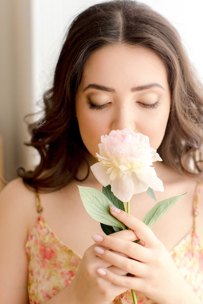 Portrait of a young woman with flower