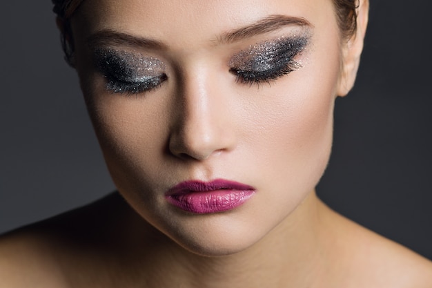 Portrait of young woman with glamorous make-up