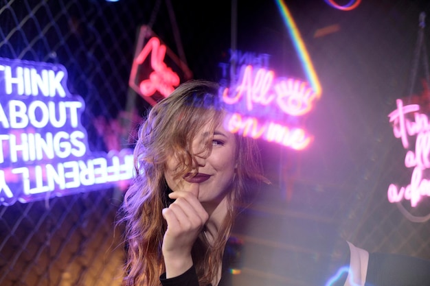 Portrait of young woman with illuminated text