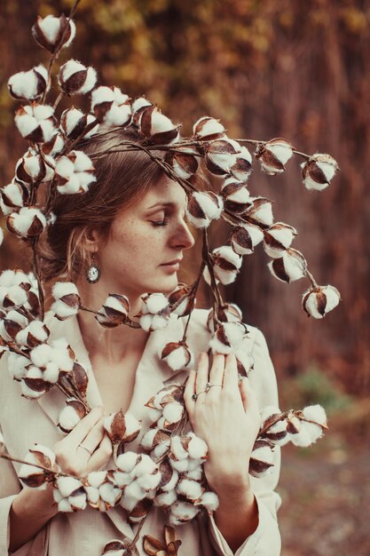 Portrait of young woman with leaves