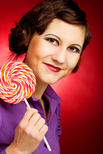 Portrait of young woman with lollipop