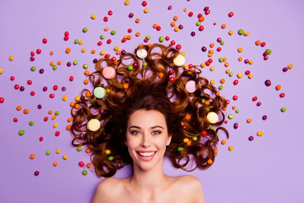 Portrait young woman with macaroons in hair