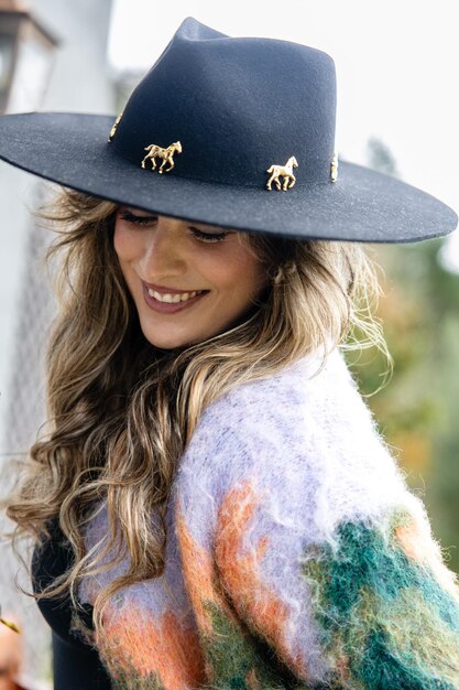 Portrait of young woman with mane and brimmed hat vertical photo