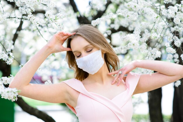 Ritratto di giovane donna con maschera in giardino