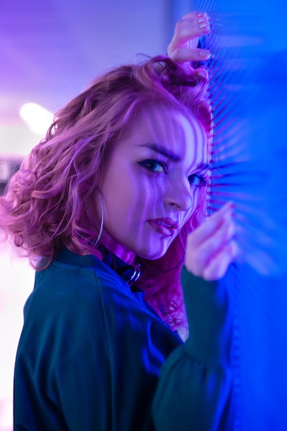 Portrait of a young woman with mixed artificial light and reflections