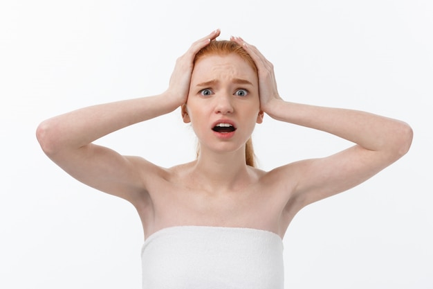 Portrait of young woman with shocked facial expression.