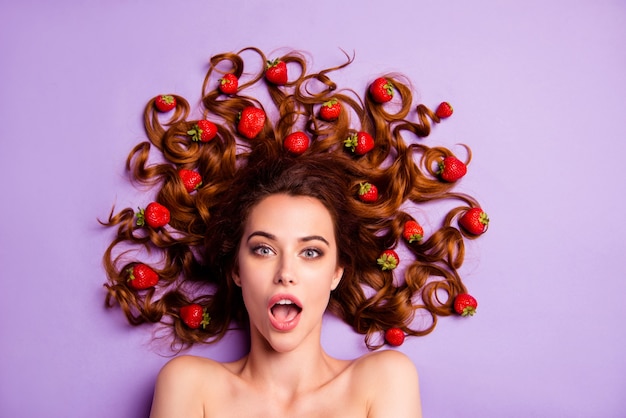 Portrait young woman with strawberries in hair