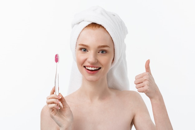 Portrait of young woman with toothbrush.