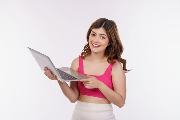 Portrait of young woman working on laptop computer isolated over white background