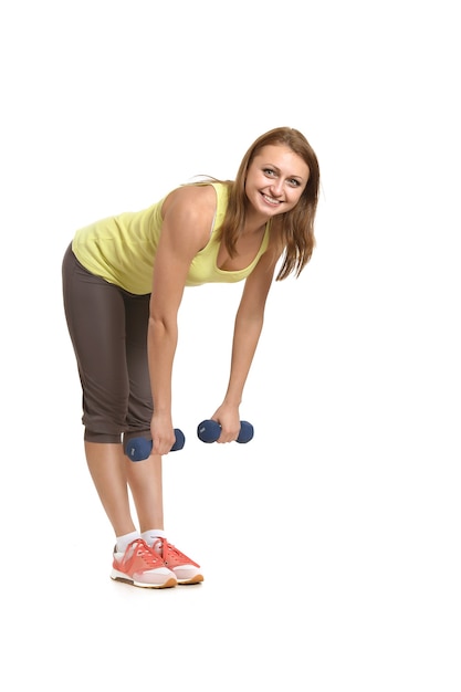 Portrait of young woman workout with dumbbells on white