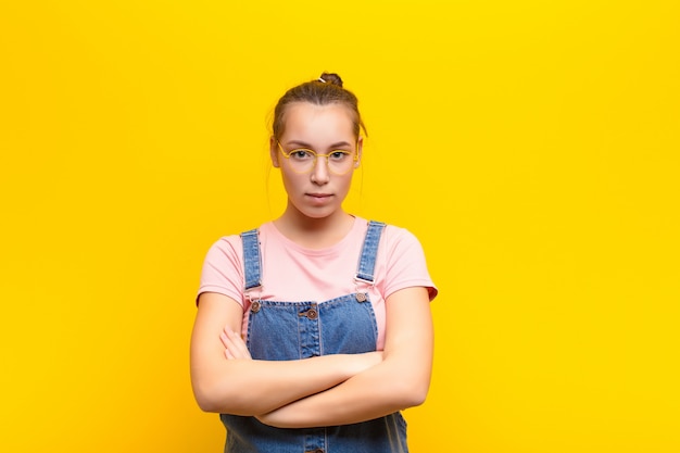 Portrait of a young woman on a yellow background