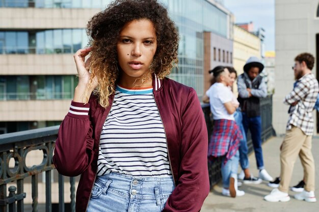 Portrait of young woman and young people in the background