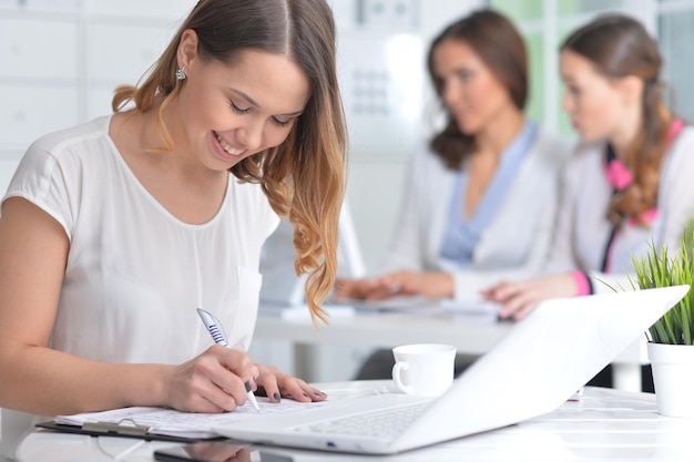 Portrait of young women working in modern office