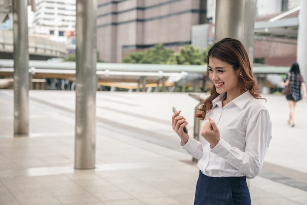 Portraits of beautiful asian woman look cheerful and confidence is standing and  feeling success