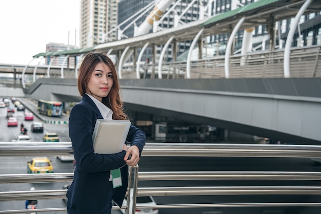 Portraits of beautiful asian woman look cheerful and confidence is standing in outdoors