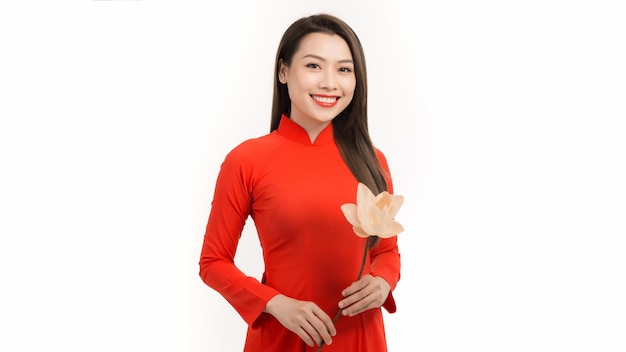 Portraits of cute lady with Vietnam culture traditional dress Ao dai is famous and holding lotus flowers