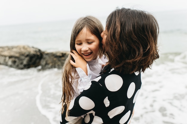 portraits of mom and daughter on the  sea beach 