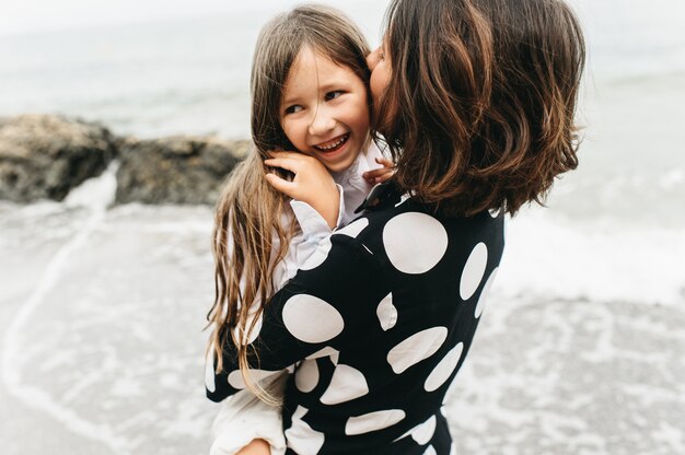 portraits of mom and daughter on the  sea beach 