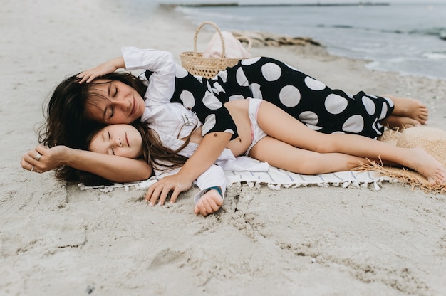 portraits of mom and daughter on the  sea beach 