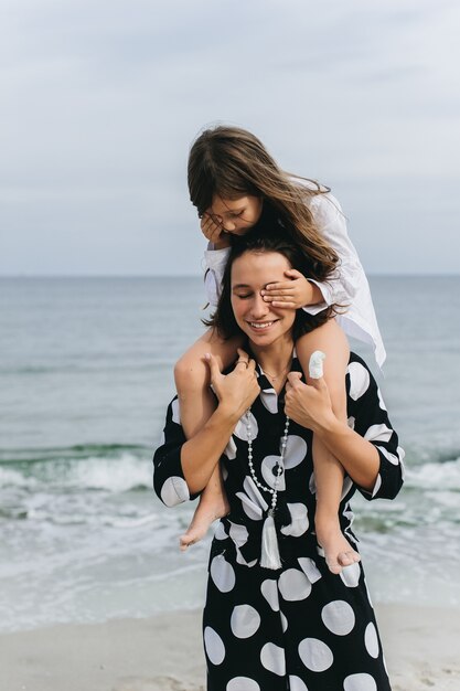 portraits of mom and daughter on the  sea beach 