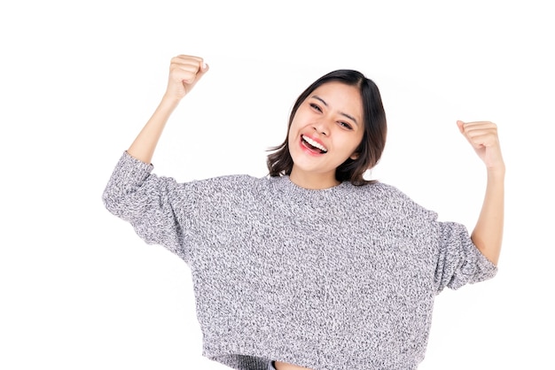 Portraits of young Asian women. Raise both arms. With a smiling face happily, a beautiful woman with a sense of self-confidence, looks good, happy on a white background.