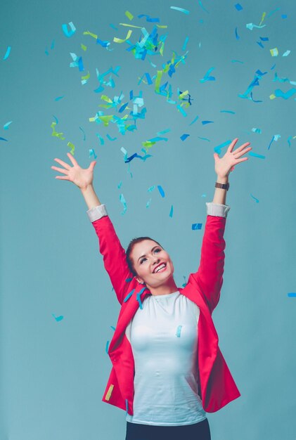 Portreit beautiful happy woman at celebration party with confetti Birthday or New Year eve celebrating concept