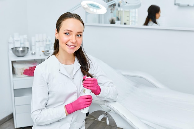 Portret jonge mooie schoonheidsspecialist in cosmetologie kabinet mooie blanke vrouw op een cosmetologie procedure Wellness center gezondheidszorg kliniek cosmetologie