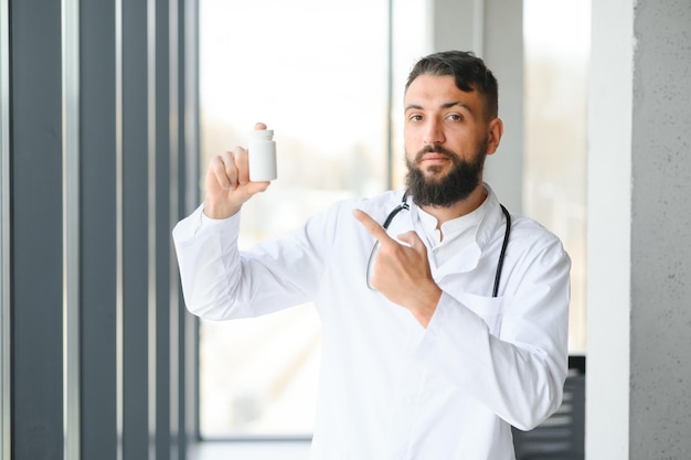 Portret van aangename jonge Arabische dokter in witte jas