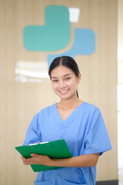 Portret van Aziatische zelfverzekerde glimlachende vrouwelijke verpleegster die in het ziekenhuisgezondheidszorgconcept werkt x9