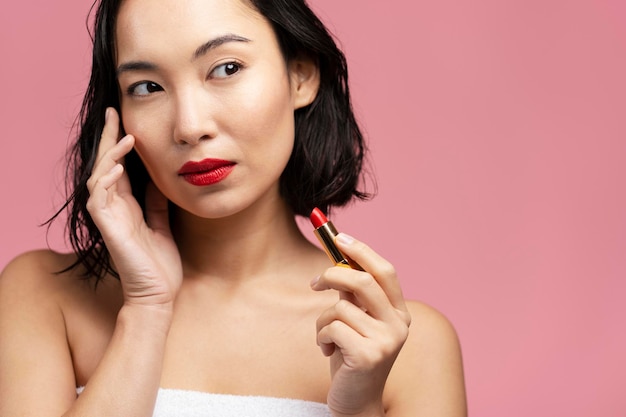 Portret van donkerbruine Aziatische vrouw met kort haar en rode lippen