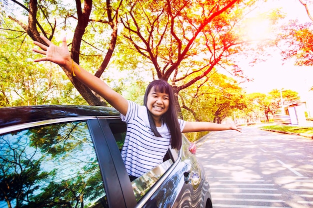 Foto portret van een gelukkige jonge vrouw in een auto