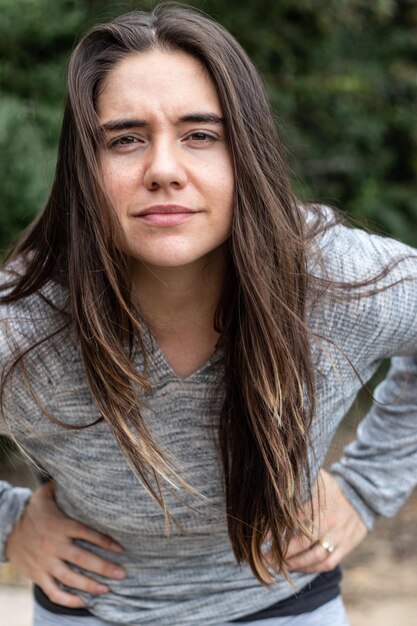 Foto portret van een glimlachende jonge vrouw die buiten staat