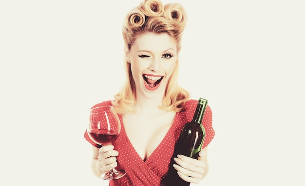 Portret van een glimlachende knipogende jonge vrouw met een glas rode wijn, mooie blonde vrouw met rode wijn