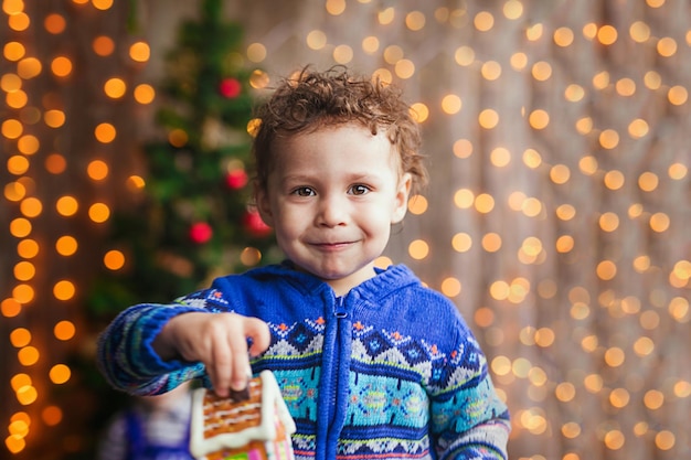 Portret van een glimlachende krullende jongen op een kerstfeestje