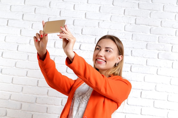 Foto portret van een glimlachende vrouw die smartphone gebruikt